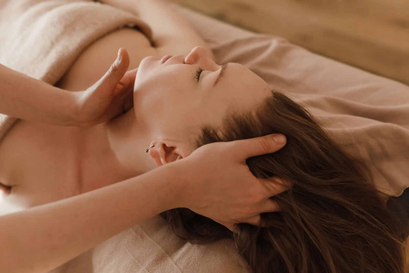 Therapist giving a relaxing head and hair massage