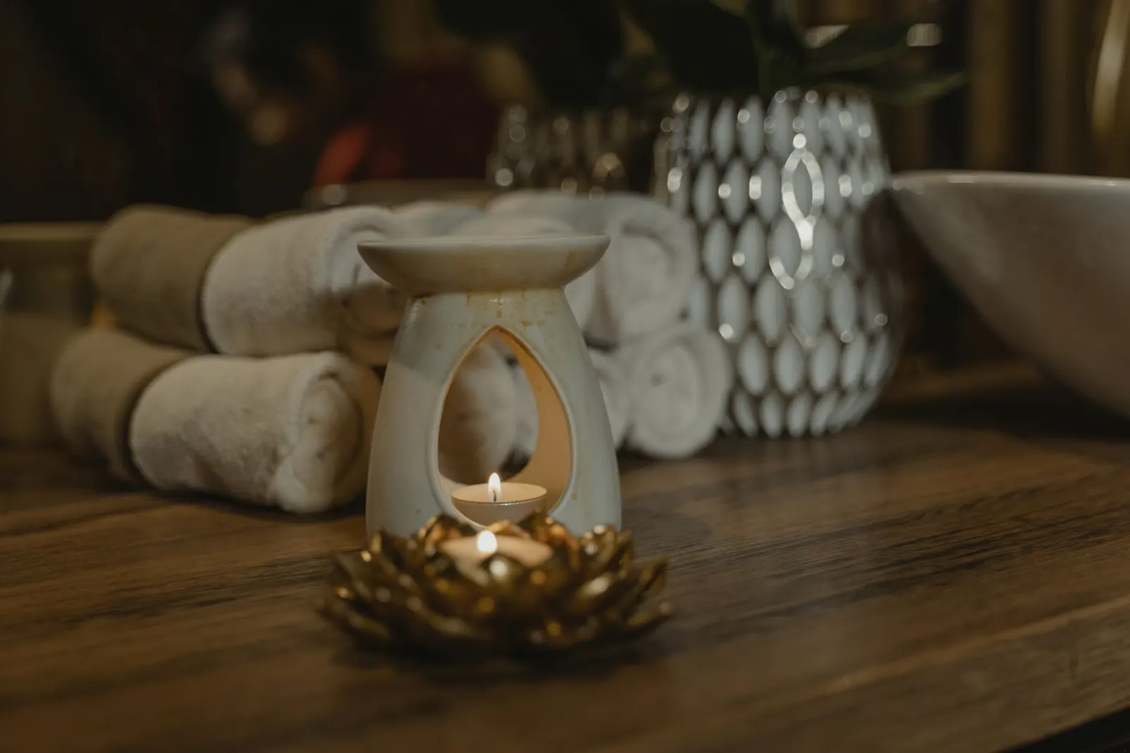 Rolled towels and a lit candle in the spa
